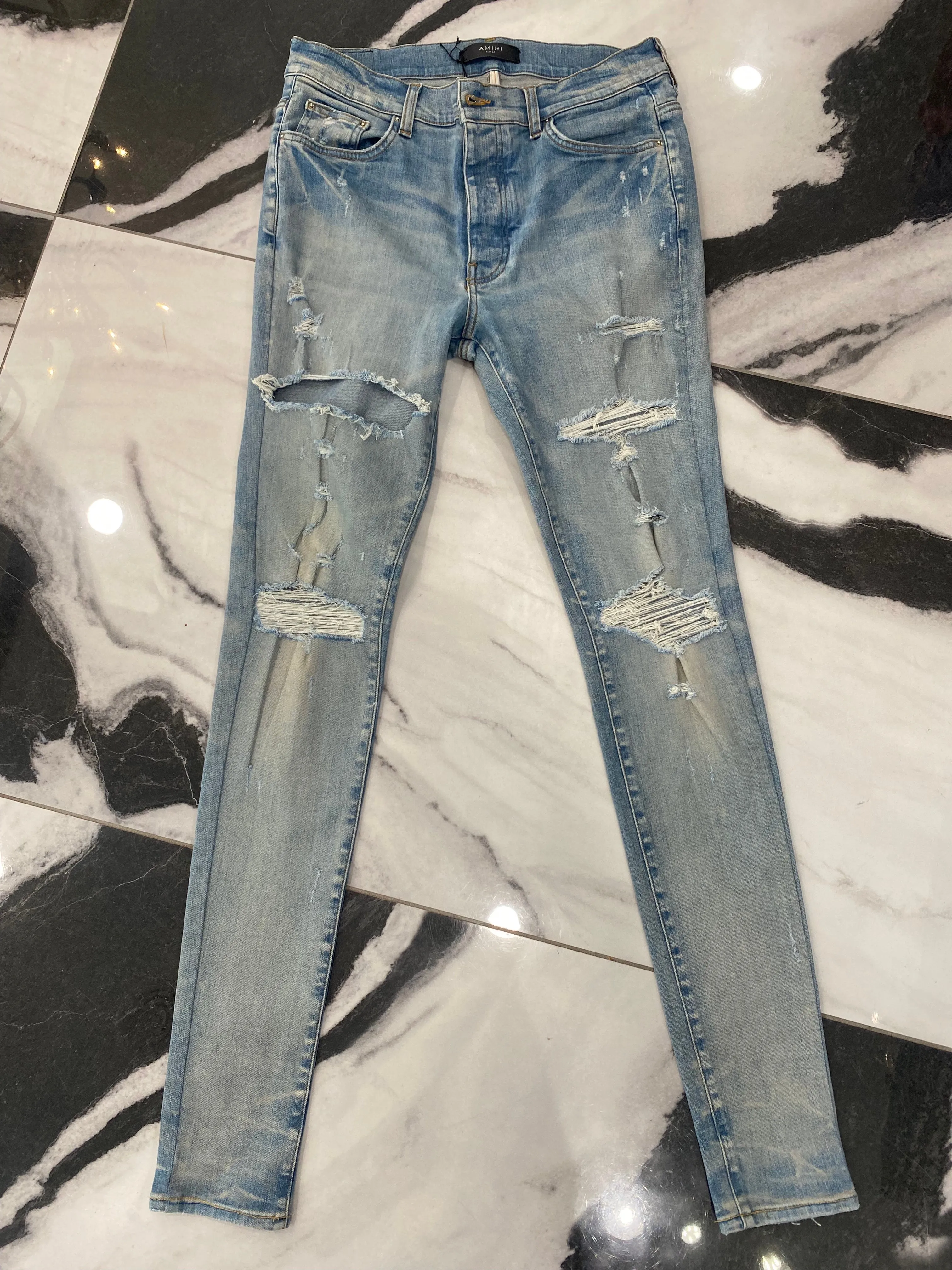 AMIRI DISTRESSED SKINNY JEANS